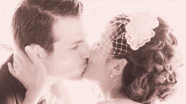 Bride and Groom kiss after outdoor wedding ceremony